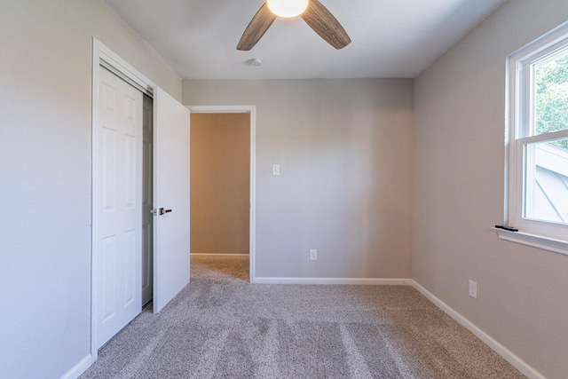 unfurnished bedroom with carpet floors and ceiling fan