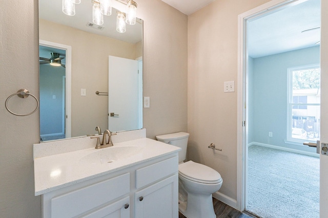 bathroom featuring vanity, toilet, ceiling fan, and hardwood / wood-style floors