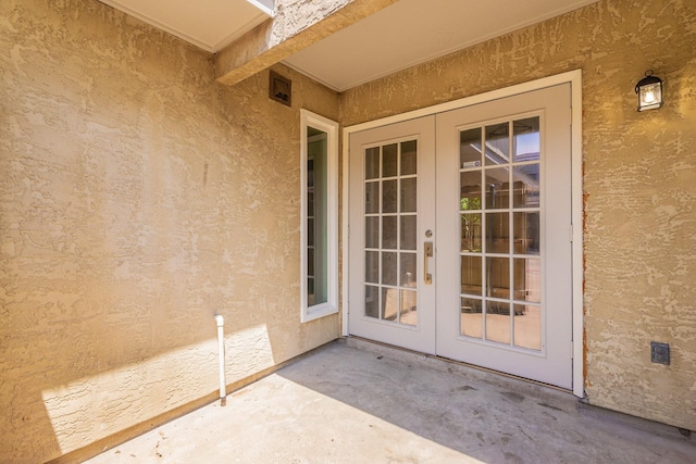 view of exterior entry featuring french doors