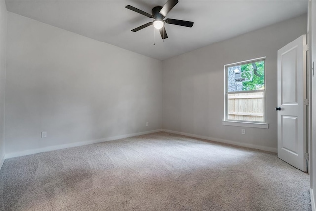 carpeted empty room featuring ceiling fan