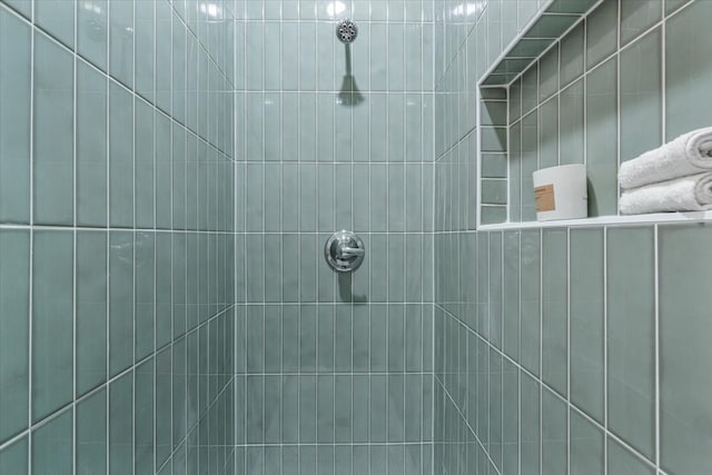 bathroom with tiled shower