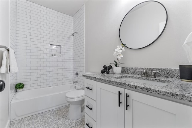 full bathroom featuring tile patterned flooring, toilet, vanity, and tiled shower / bath