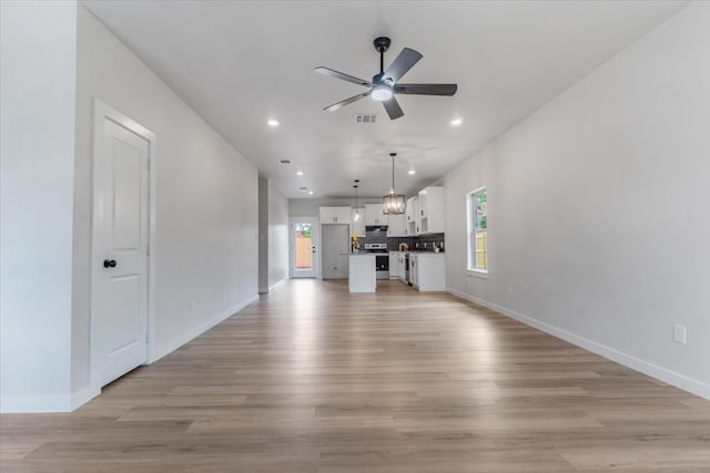 unfurnished living room with ceiling fan and light hardwood / wood-style flooring