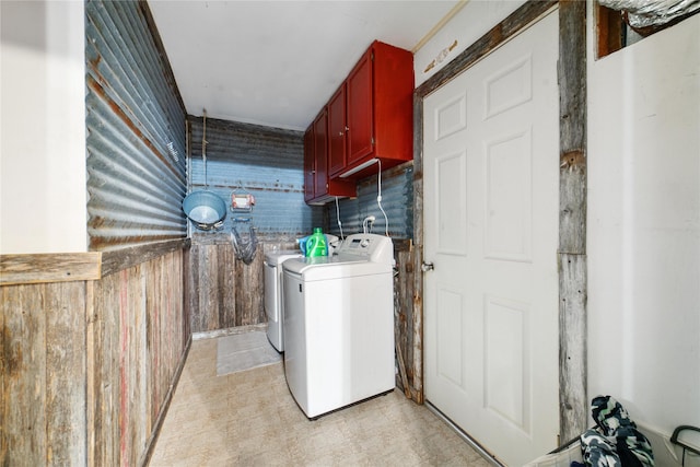 laundry room with cabinets and washer and clothes dryer