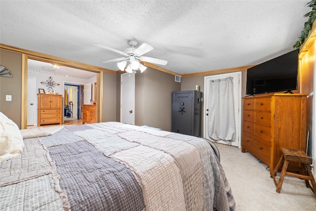 carpeted bedroom featuring ceiling fan and a textured ceiling