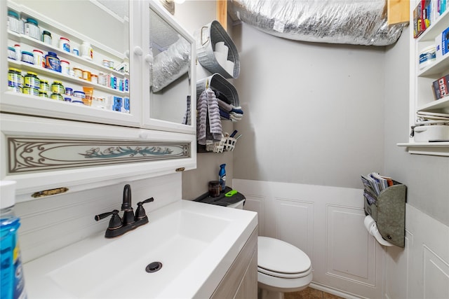 bathroom featuring toilet and vanity