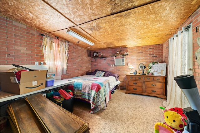 carpeted bedroom with a wall mounted AC, brick wall, and multiple windows