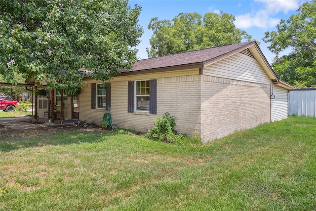 view of side of home featuring a yard