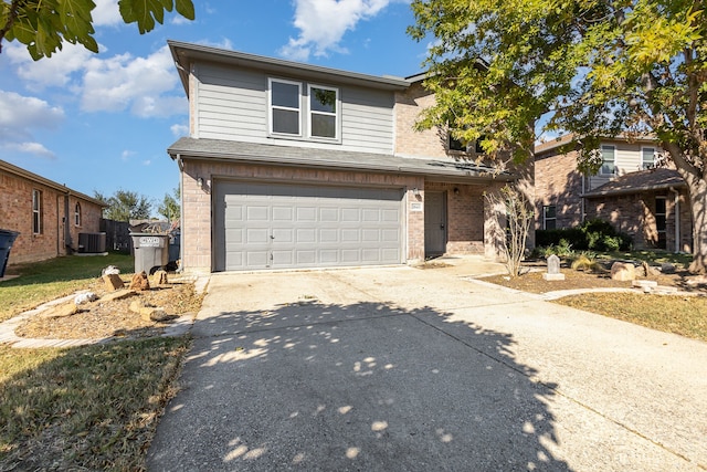 view of front property with central air condition unit and a garage