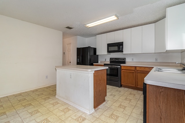 kitchen with sink, black appliances, a center island, white cabinets, and a textured ceiling