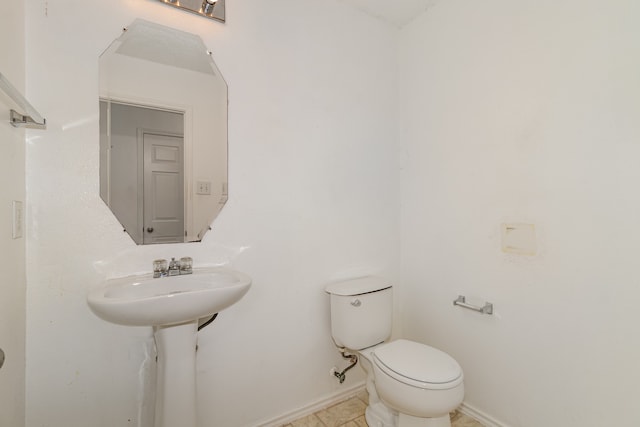 bathroom featuring toilet and tile patterned flooring