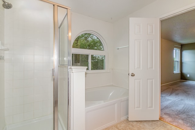 bathroom featuring shower with separate bathtub and tile patterned flooring