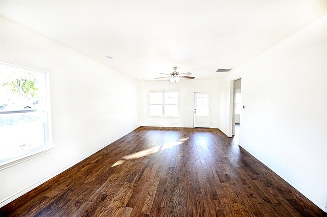 empty room with ceiling fan and dark wood-type flooring