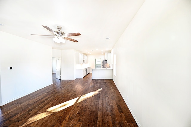 unfurnished living room with ceiling fan and dark wood-type flooring