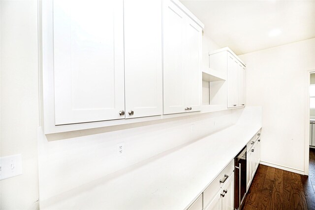 interior space featuring white cabinets and dark hardwood / wood-style flooring