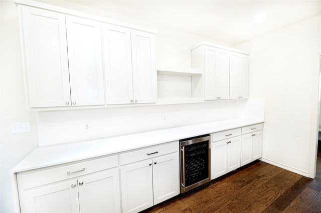 kitchen featuring white cabinets, dark hardwood / wood-style floors, and beverage cooler