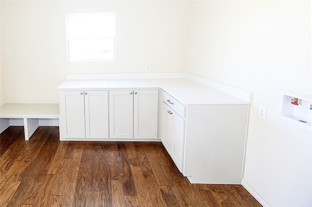 washroom featuring cabinets, hookup for a washing machine, and dark hardwood / wood-style floors