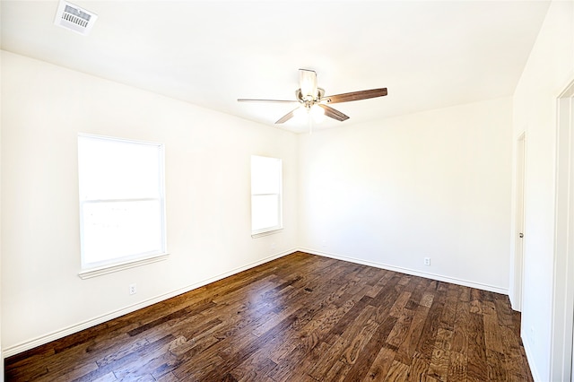 spare room with dark hardwood / wood-style floors and ceiling fan