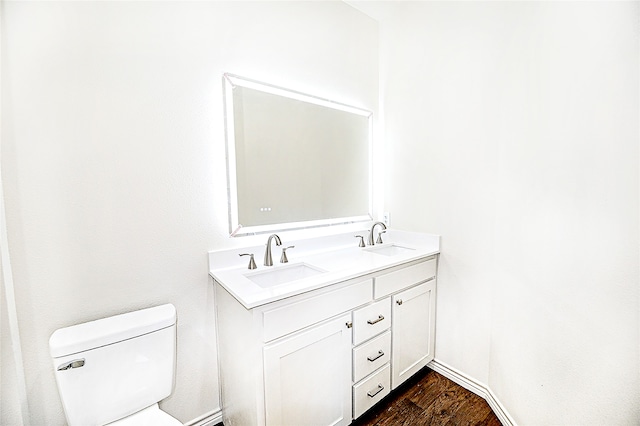 bathroom featuring hardwood / wood-style floors, vanity, and toilet