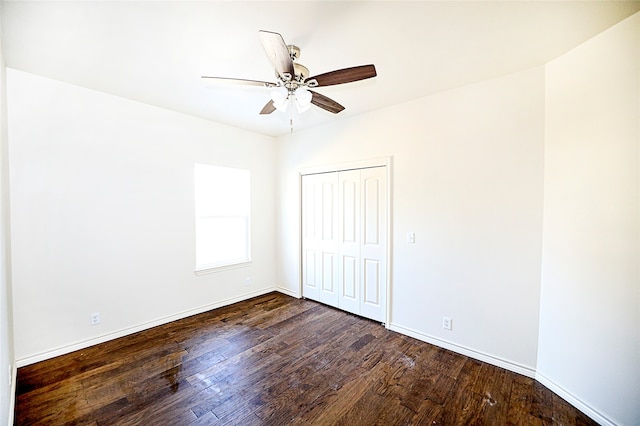 unfurnished bedroom with ceiling fan, a closet, and dark hardwood / wood-style floors