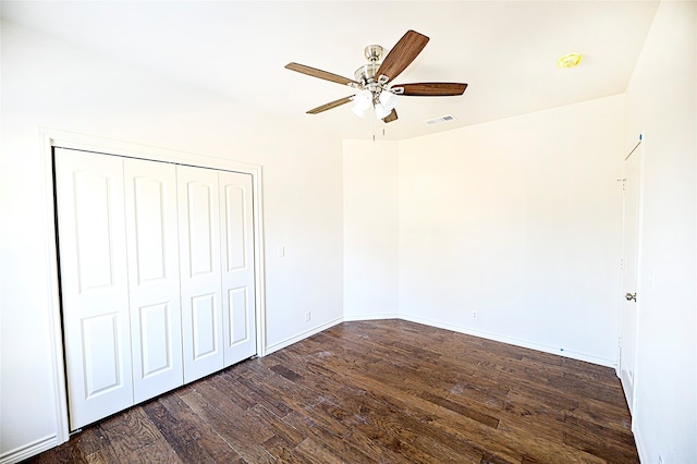 unfurnished bedroom featuring a closet, ceiling fan, and dark hardwood / wood-style flooring