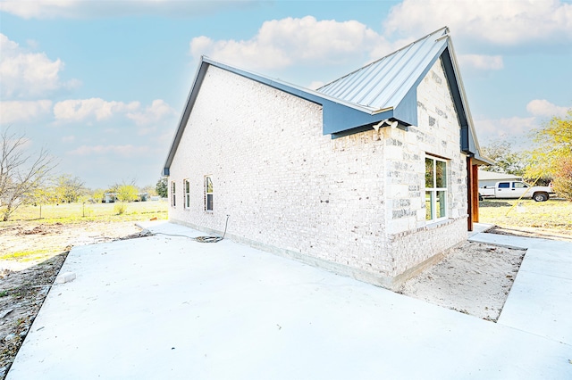 view of side of property featuring a patio area