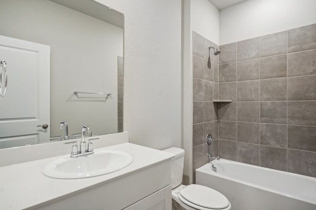 full bathroom featuring vanity, toilet, and tiled shower / bath