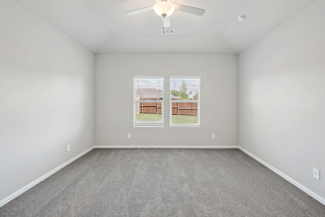 carpeted spare room featuring ceiling fan and lofted ceiling