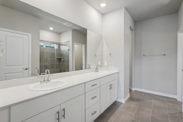 bathroom with vanity, a shower with shower door, and tile patterned floors