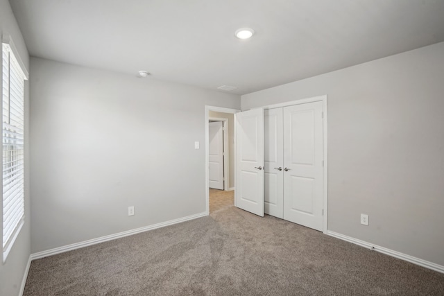 unfurnished bedroom featuring a closet and carpet