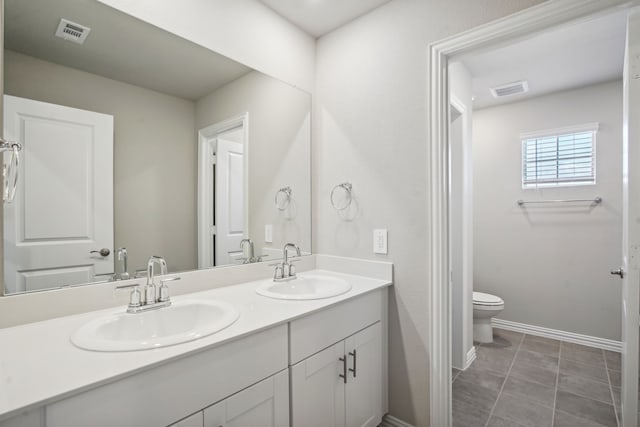 bathroom with vanity, tile patterned flooring, and toilet