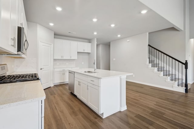 kitchen featuring stainless steel appliances, sink, dark hardwood / wood-style floors, and white cabinets