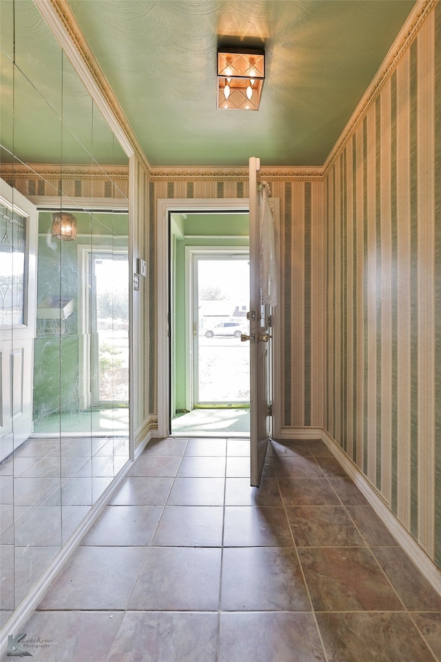 doorway with dark tile patterned flooring