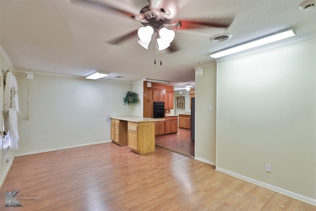 kitchen featuring crown molding, a textured ceiling, black appliances, ceiling fan, and light hardwood / wood-style floors