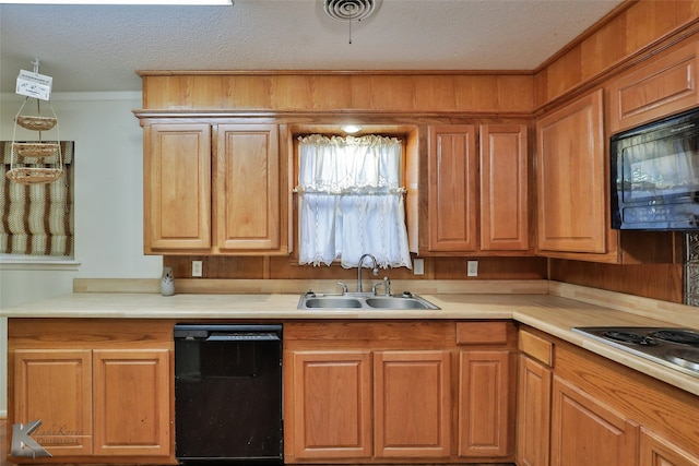 kitchen with black appliances, a textured ceiling, and sink