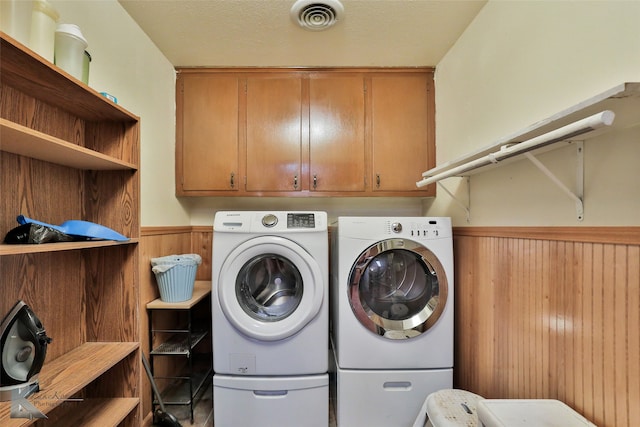 laundry area featuring cabinets and washer and clothes dryer