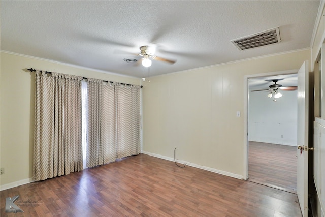 unfurnished room with a textured ceiling, ceiling fan, ornamental molding, and hardwood / wood-style flooring