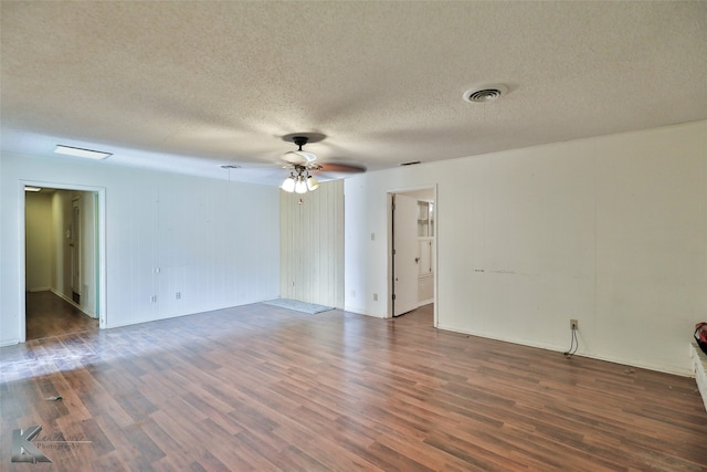 spare room with a textured ceiling, ceiling fan, and dark hardwood / wood-style flooring