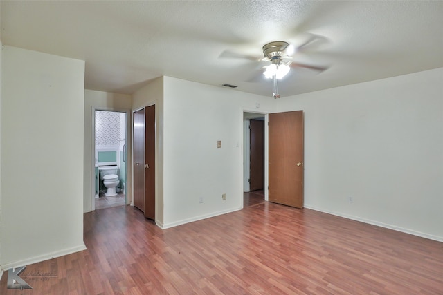 spare room with wood-type flooring, a textured ceiling, and ceiling fan