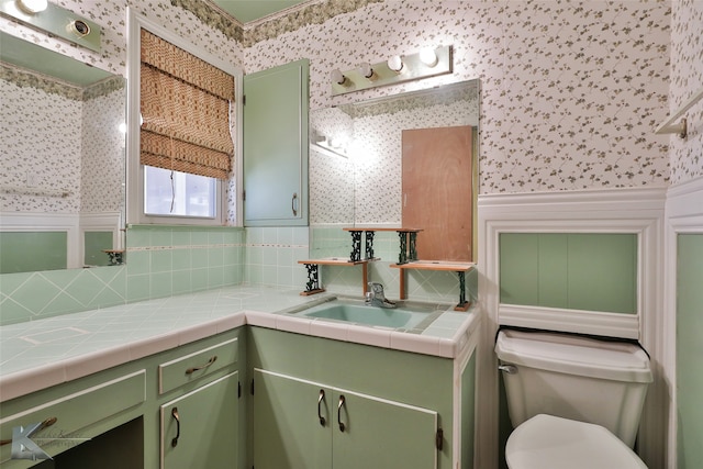 bathroom with backsplash, toilet, and vanity