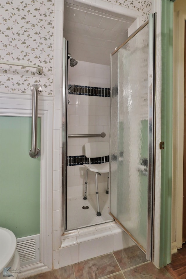 bathroom with toilet and walk in shower