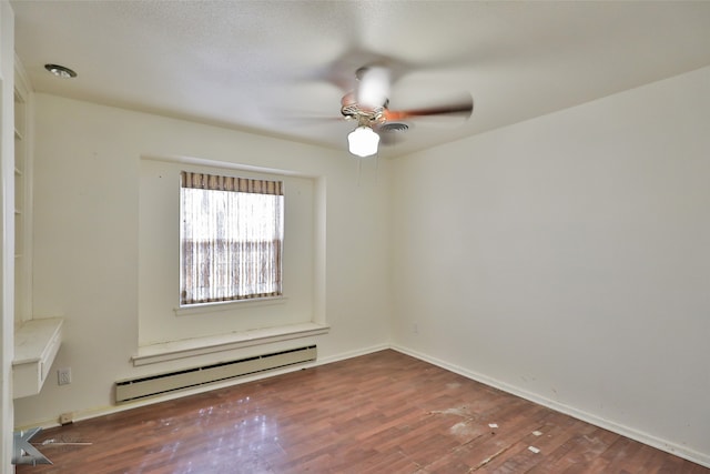 spare room with hardwood / wood-style flooring, baseboard heating, and ceiling fan