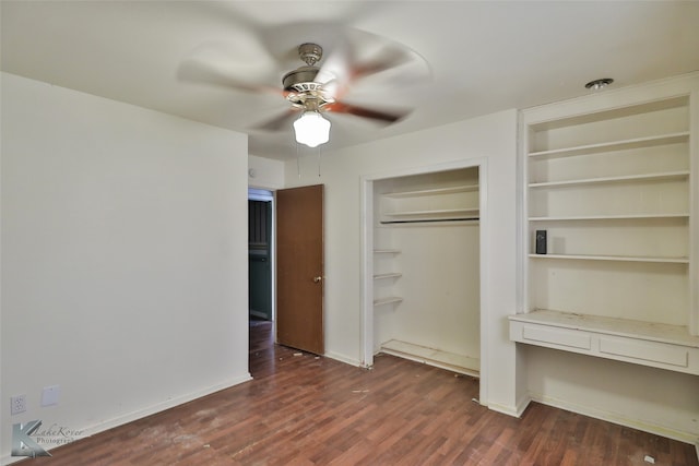 unfurnished bedroom featuring dark wood-type flooring, ceiling fan, and a closet