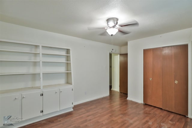 interior space with a closet, ceiling fan, dark hardwood / wood-style floors, and a textured ceiling