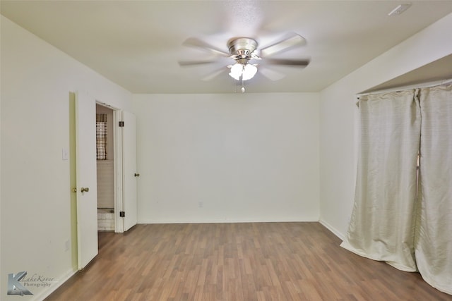 empty room featuring ceiling fan and wood-type flooring