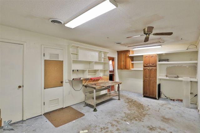 miscellaneous room featuring a textured ceiling and ceiling fan