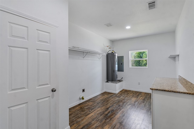 laundry room with hookup for an electric dryer, electric panel, dark wood-type flooring, and water heater