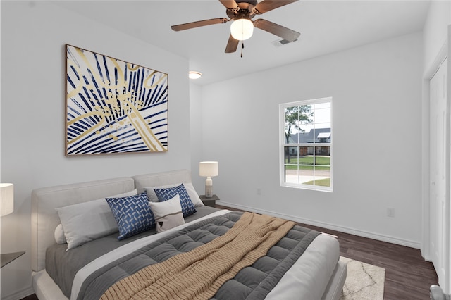 bedroom with ceiling fan and dark hardwood / wood-style floors