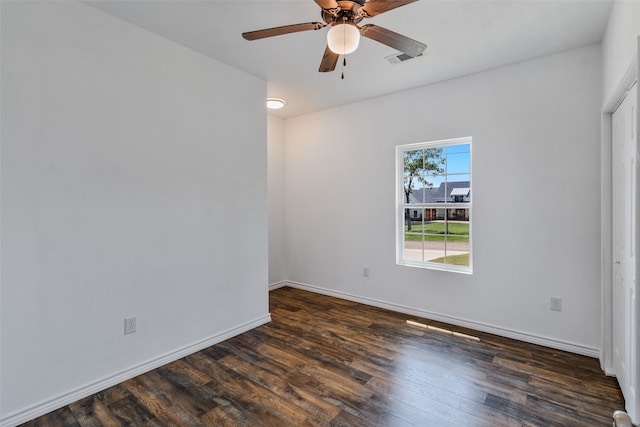 unfurnished room with ceiling fan and dark wood-type flooring