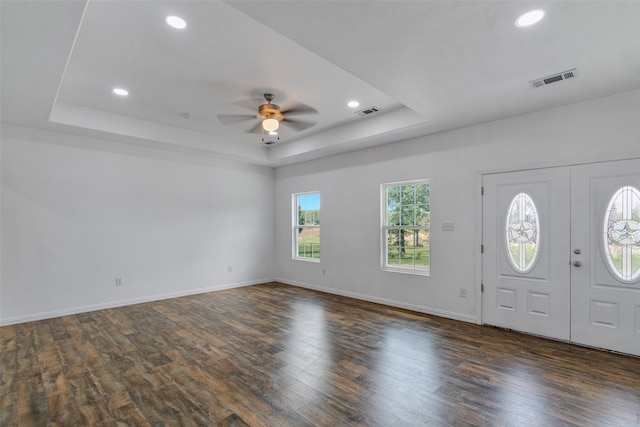 foyer with french doors, a raised ceiling, ceiling fan, and dark wood-type flooring